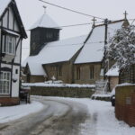 Snow and icy road way of School House Corner in Drayton st Leonard