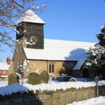 snow covering the church and churchyard