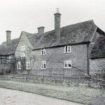 Black and White photo of bricked house with railings of Guys House